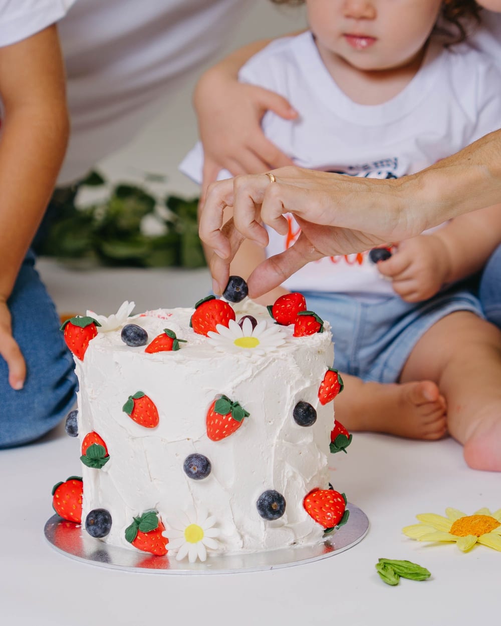 Mans petites al pastís en una sessió smash cake · Objectiu Fotògrafs, Reus
